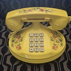This item is a vintage yellow "Empress" landline telephone, often identified as a 1973 model produced by the American Telecommunications Corporation,