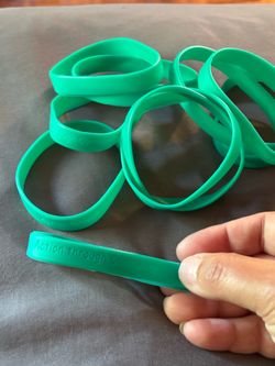 150 wristbands "Action Through Community"