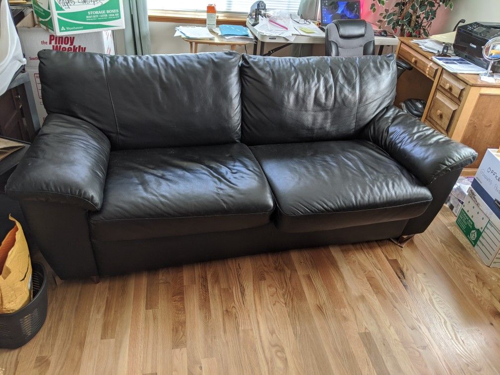 Black sofa bed, flame retardant mattress, fake leather covering. Sofa long enough for a six-footer