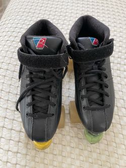 Riedell Black Quad Roller Skates with lace-up closure and velcro ankle strap.