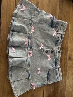 Bright denim hot topic mini skirt with baby pink bows and pockets