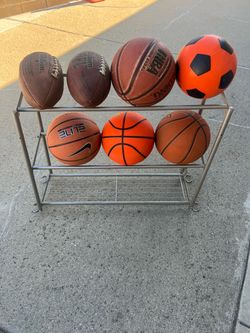Assorted basketballs and footballs