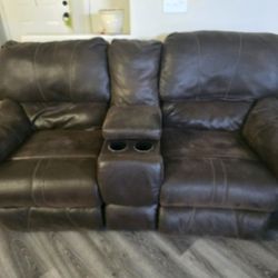 Two Brown Faux Leather Reclining couches with Console