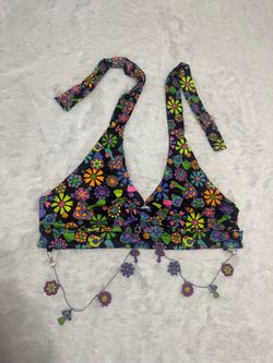 Bold floral halter crop top by iHeartRaves. Black base with bright multicolor flower print. Adjustable halter ties for a custom fit. Decorative remova