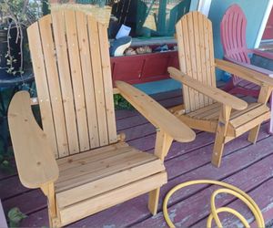 2 wooden adirondack chairs.