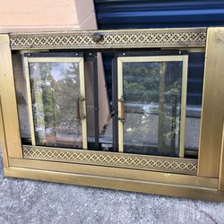 vintage antique looking brass fireplace frame with doors