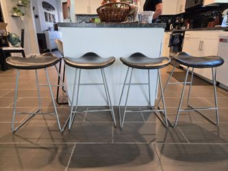 Four Gray Backless Bar Stools