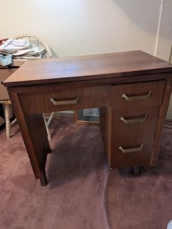 Vintage white sewing machine in cabinet