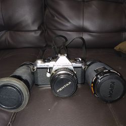 Pentax camera with 2 extra lenses.