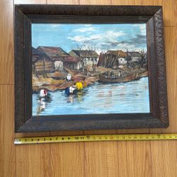 Original oil painting on canvas or board, depicting a rural riverside village scene with people washing clothes and a boat crossing the water. 