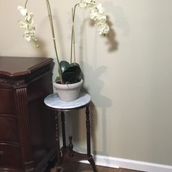 Little wood table with marble on the top with fake Orchid