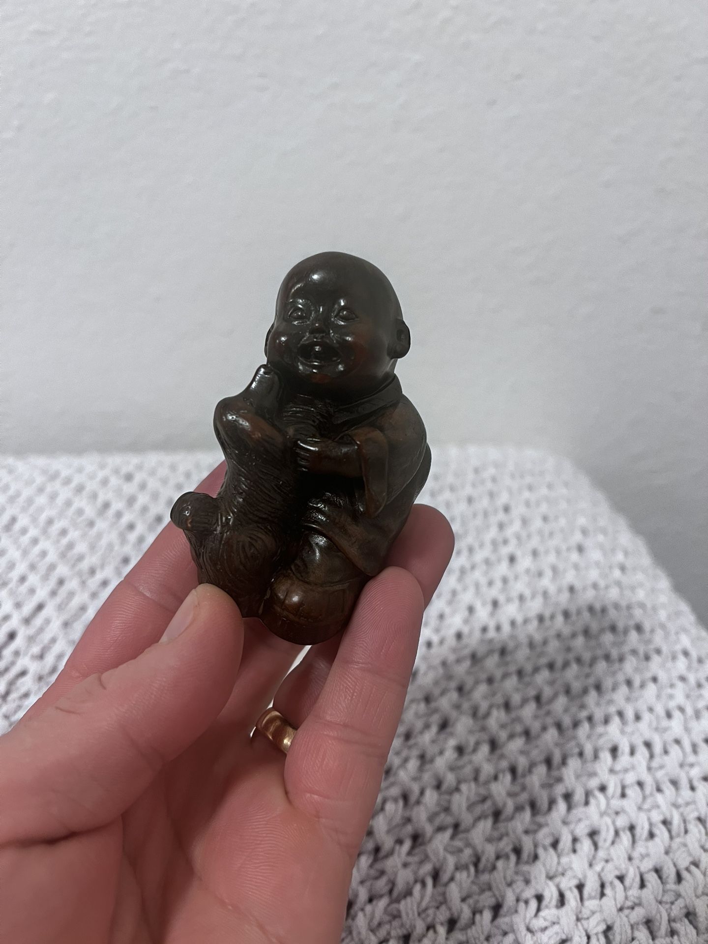 3" by 2" resin hand carved figure of a boy playing with a dog