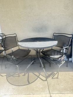 wrought iron table and two chairs 