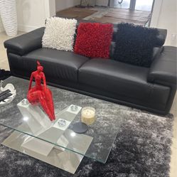 couch and coffee table with pillows