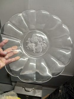 The object in the image is a Val St. Lambert Brussels Clear Crystal Fruit Scalloped Edge Intaglio Platter. Val St. Lambert is a renowned Belgian cryst
