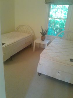 Two single beds with headboard frames mattresses