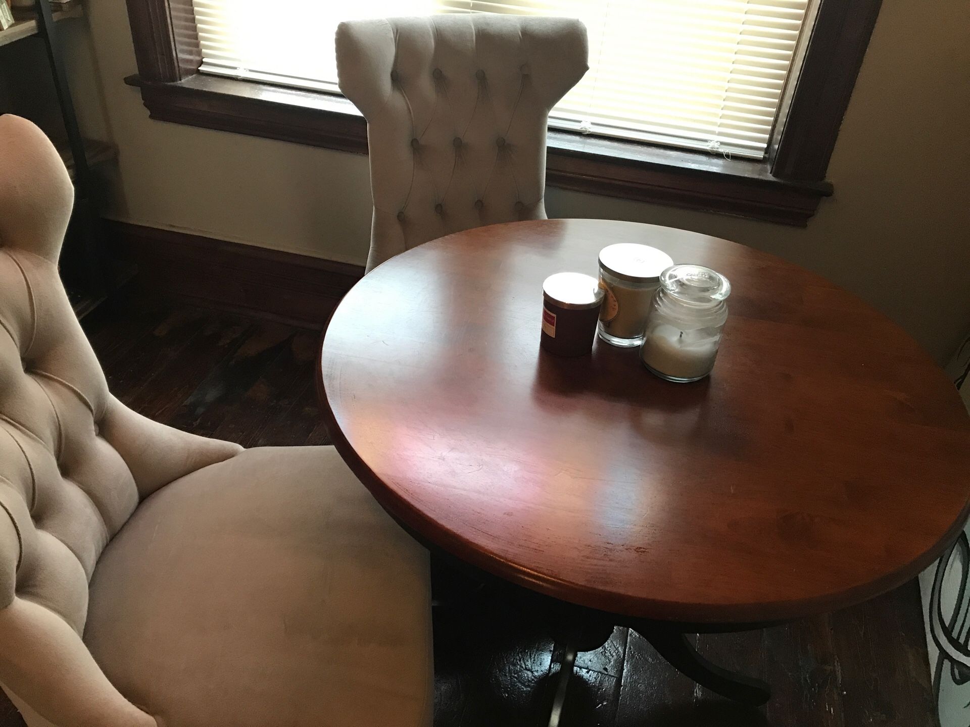 Small dining table with two upholstered chairs