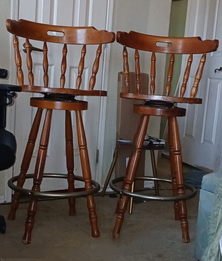 two Colonial swivel bar stools