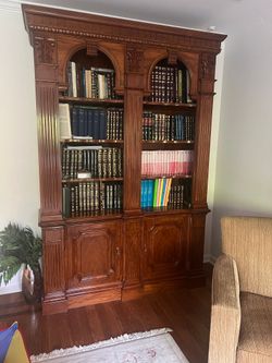 Ornate Solid Wood Bookcase with Fluted Columns and Arch Accents