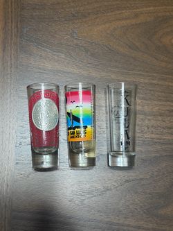 Three glass souvenir shot glasses