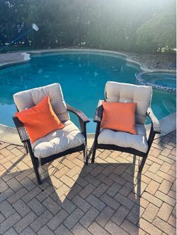 Outdoor resin wicker chairs (orange pillow not included)
