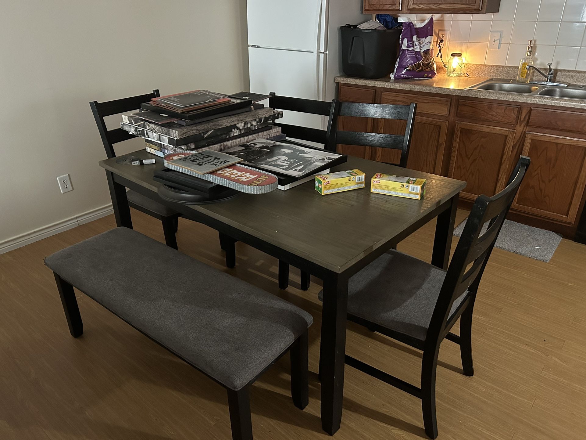Kitchen table with four chairs and a bench