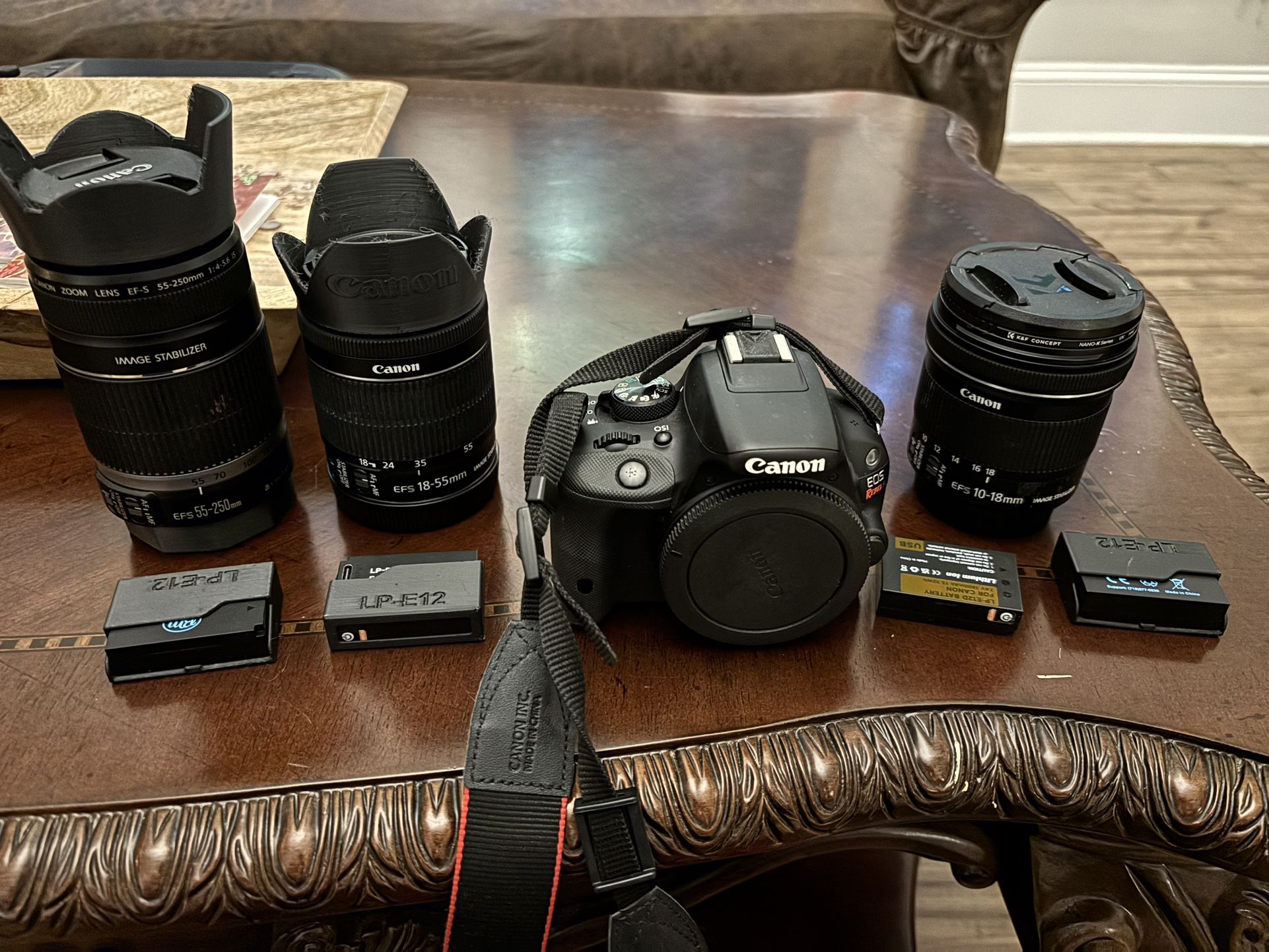 Canon SL1 /W 3 Lens, Batteries And Charger