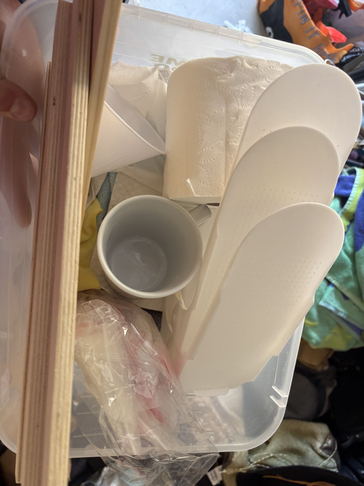 mug, several pair of white shoe inserts. toilet paper not inc