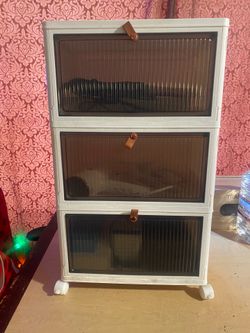 3 drawers with leather handles.