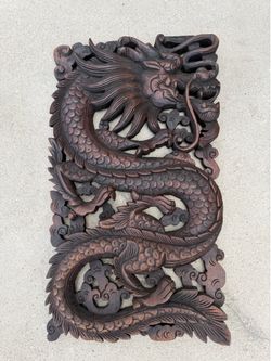 hand-carved teak wood wall panel featuring a Chinese dragon design.