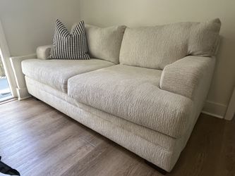 Beige two-seater sofa
