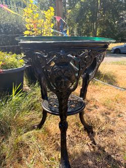 Vintage Neoclassical style cast iron table with glass top