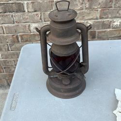 Embury No. 150 Little Supreme Kerosene Lantern with a red globe. 