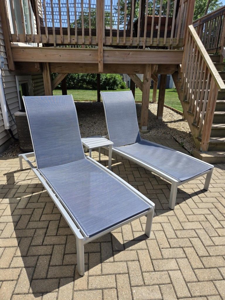 Two Pool Lounge Chairs And Side Table