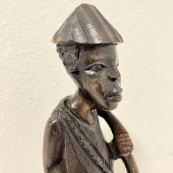 A statue of an African earth worker made of dark wood. Vintage statue Home decor
