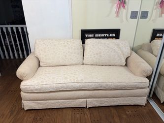 vintage couch with floral embroidery