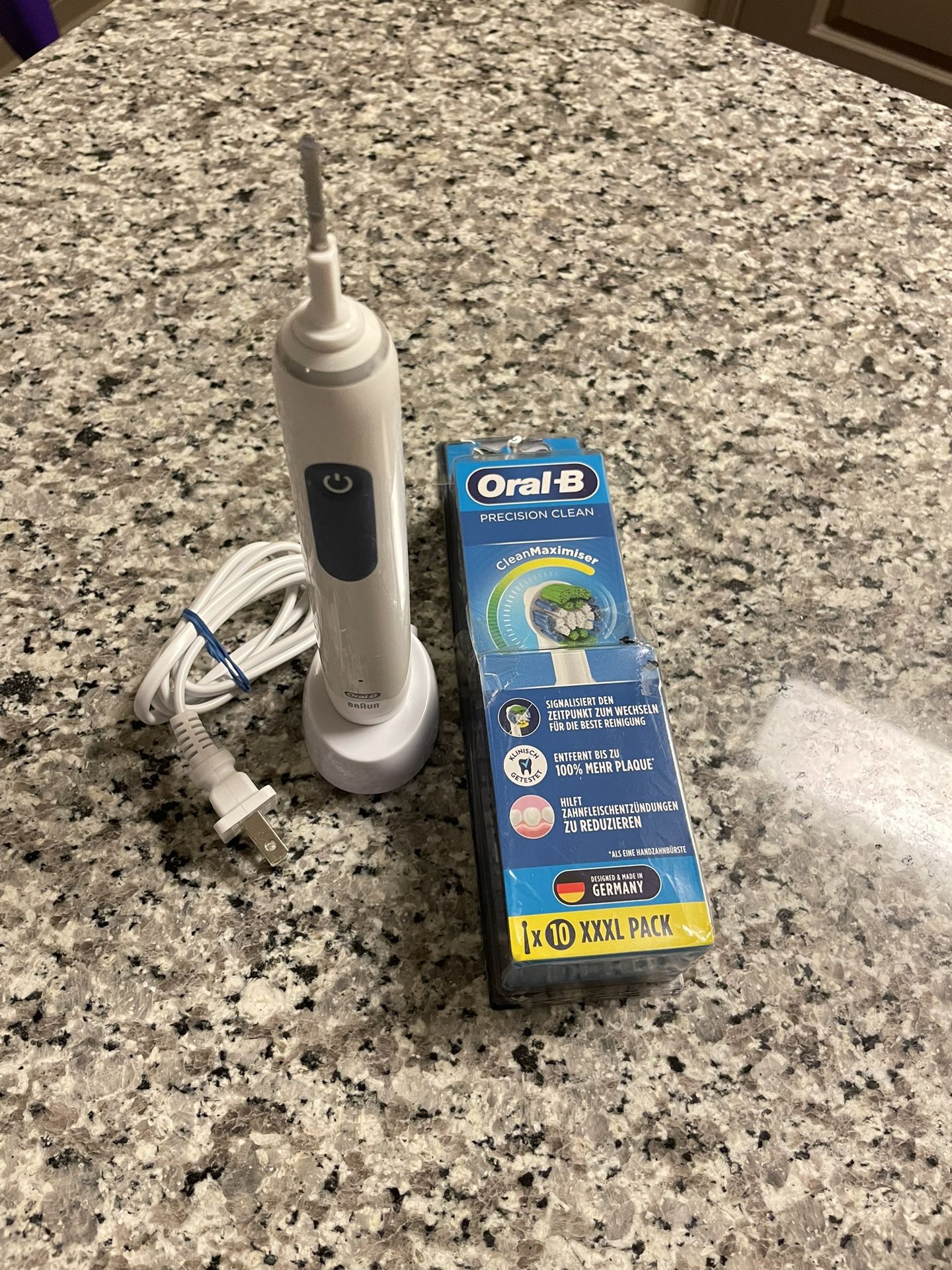 Oral-B electric toothbrush with charger plus a pack of 7 Precision Clean brush heads .