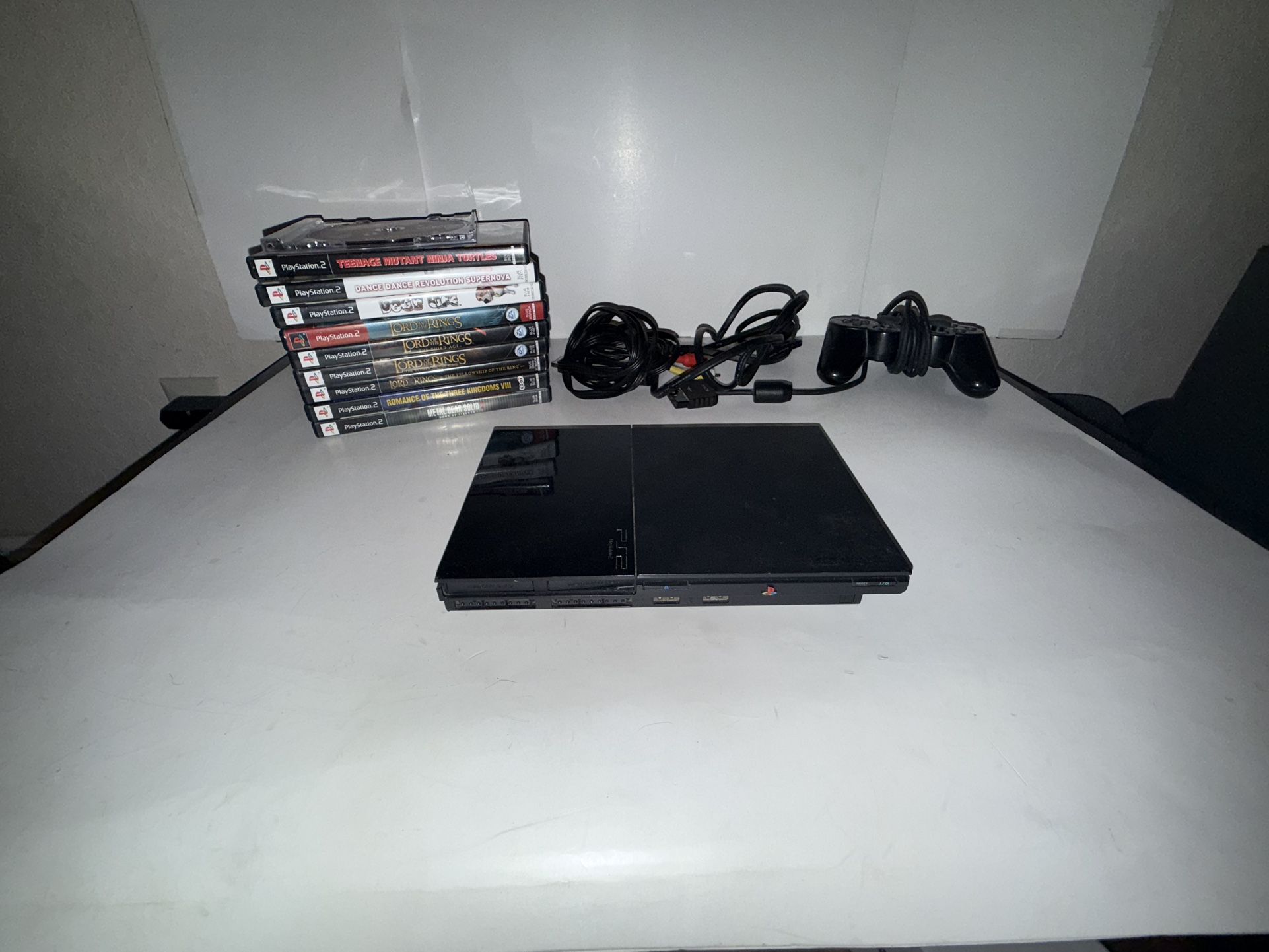 Ps2 slim console with games cords and controller