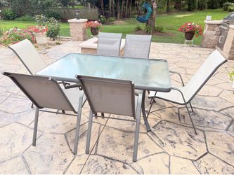Glass top patio table and six chairs