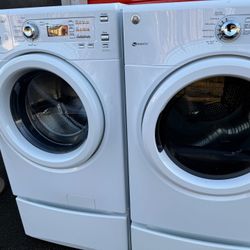 GE Front Load Washer And Electric Dryer On Pedestals 