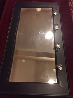 Mirror framed with hooks