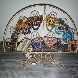 Gold-tone metal jewelry organizer stand, featuring multiple hooks for hanging bracelets or necklaces 