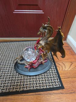 Dragon statue with glass orb