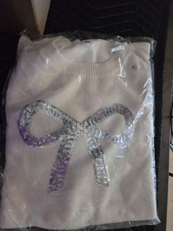 Ladies new sweater w silver sequin bow on front. Sz Xl