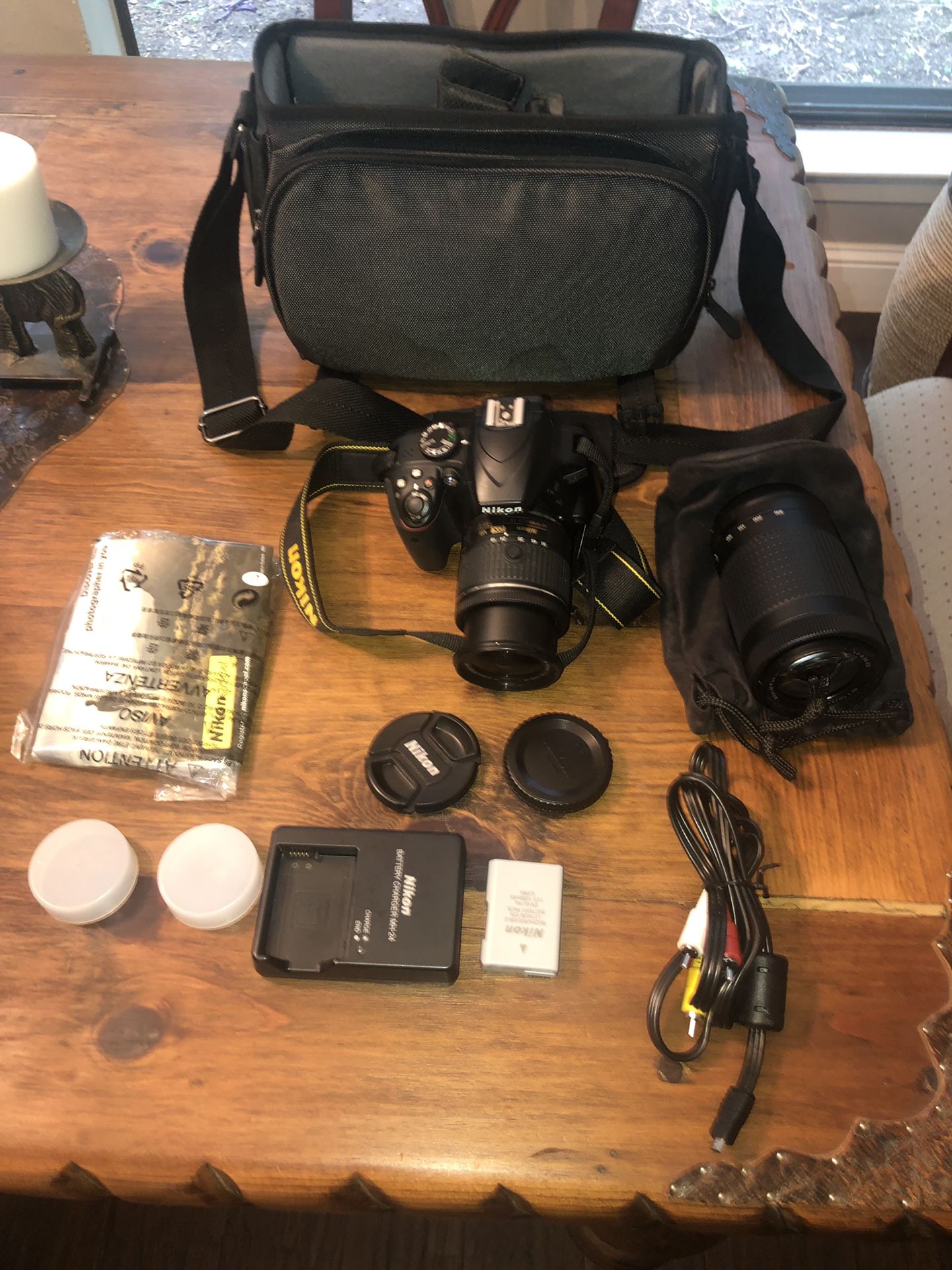 Nikon 5100 Camera with 2 lenses, battery, charger, cord, camera case.
