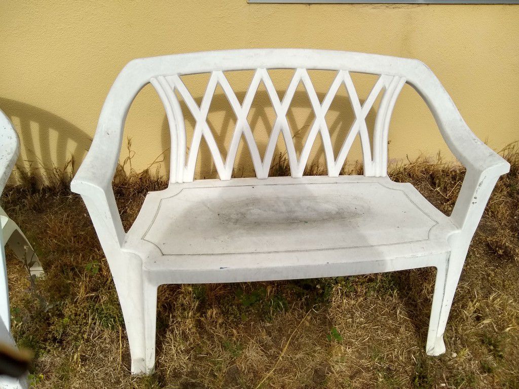 Two white outdoor benches