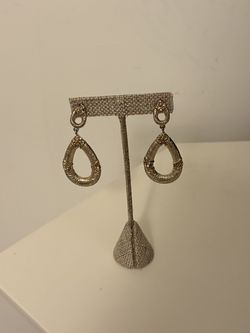 Carters Jewels long teardrop earrings have an open design with a wrap-around twisted wire texture and honey-colored rhinestone accents.