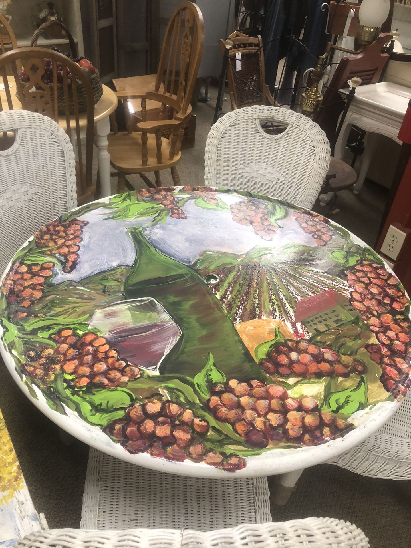 Vintage metal patio table with right iron base winery scene painted with three layers of clear includes four vintage wicker patio chairs
