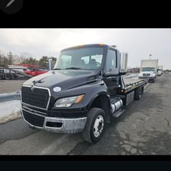 We are pleased to offer a rollback truck for sale today. This 

2023 International MV607 features 110,000 miles, a Cummins Engine, and does not requir