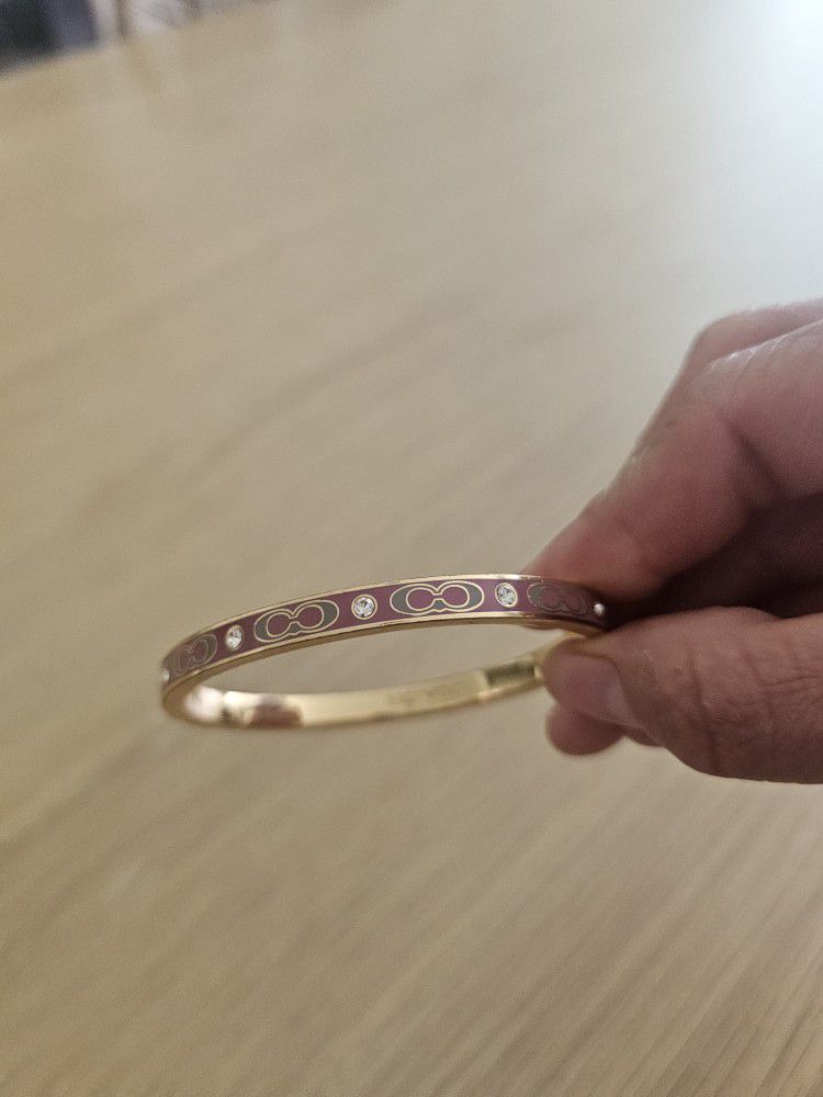 Coach bracelet Gold and Pink.
